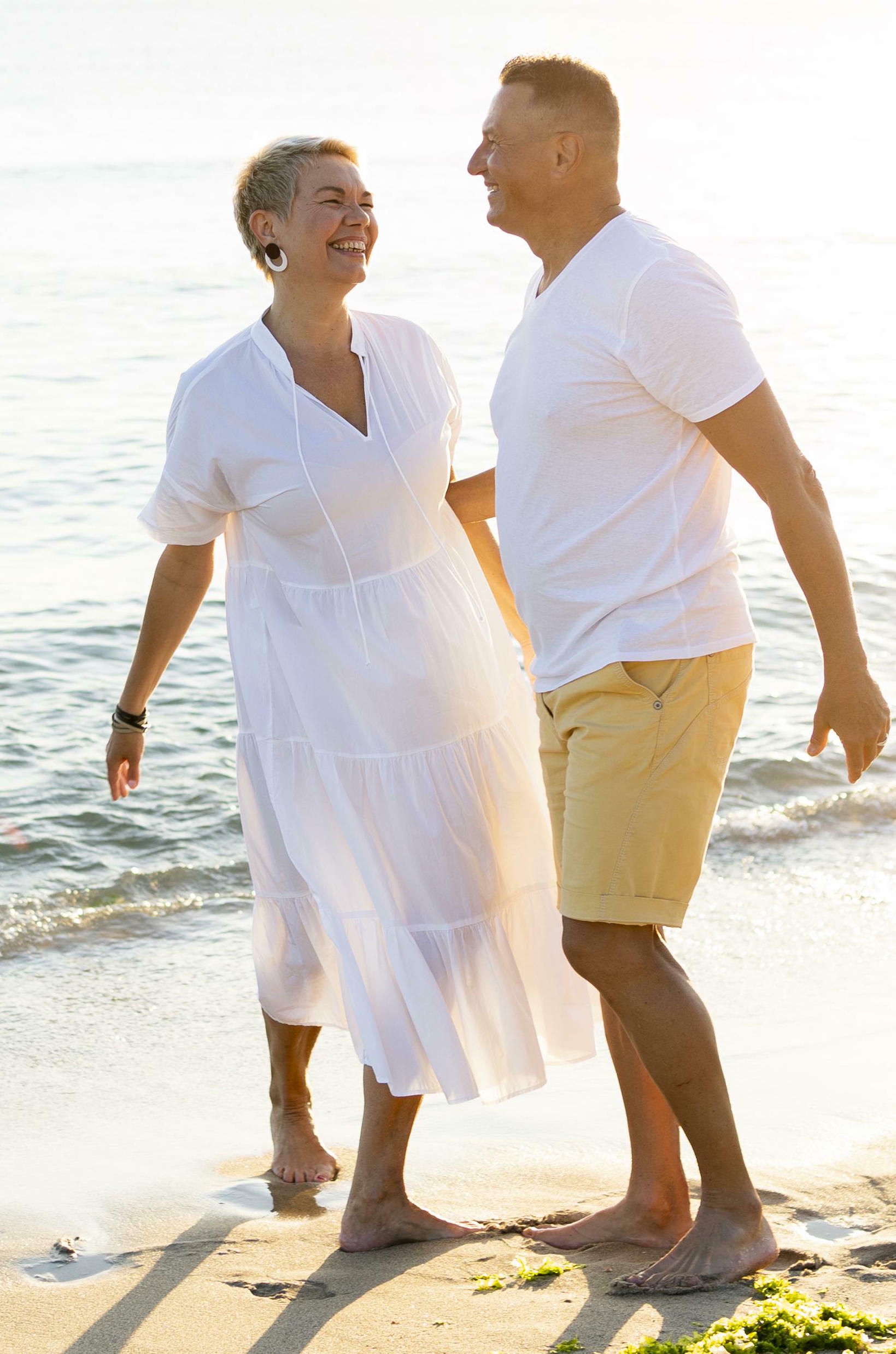 Couple walking on beach mobile